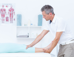 A man massages a patient's leg