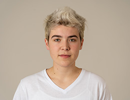 A photo of a teenage girl from the shoulders up, looking at the camera.