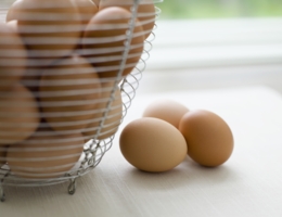 Metal basket with brown eggs.