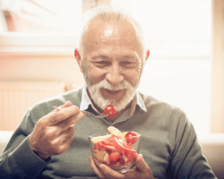 Older man enjoying a salad.