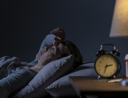 A woman lying awake in bed