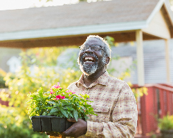  Smiling man holding a plant