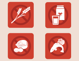 Four illustrations of wheat, milk, nuts and fish/shellfish within "no" symbols. 