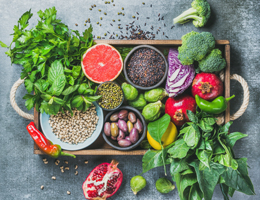 A tray with a variety of fruits, vegetables and legumes.